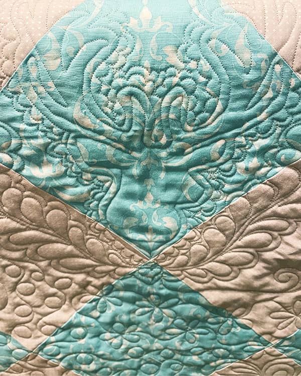 A bold custom long arm quilting design can strongly accent a motif